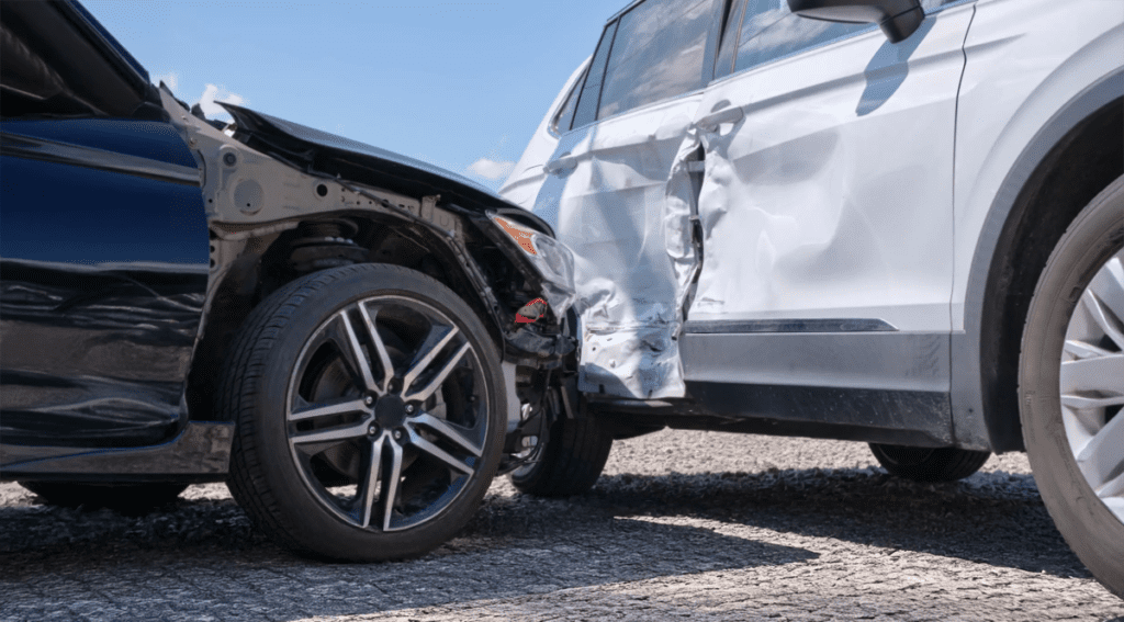 A damaged car after a collision, showing significant impact from crashing into another vehicle.